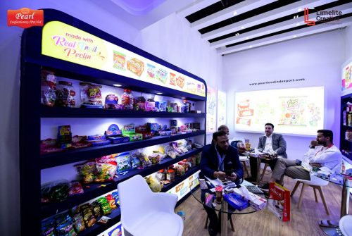 Pearl Confectionery exhibition booth at Gulfood with product shelves and meeting area